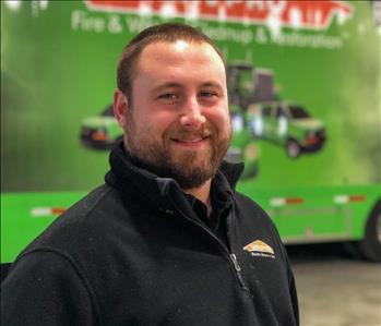 man in front of a SERVPRO trailer