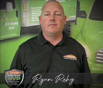 SERVPRO Employee in front of a trailer with SERVPRO Graphics
